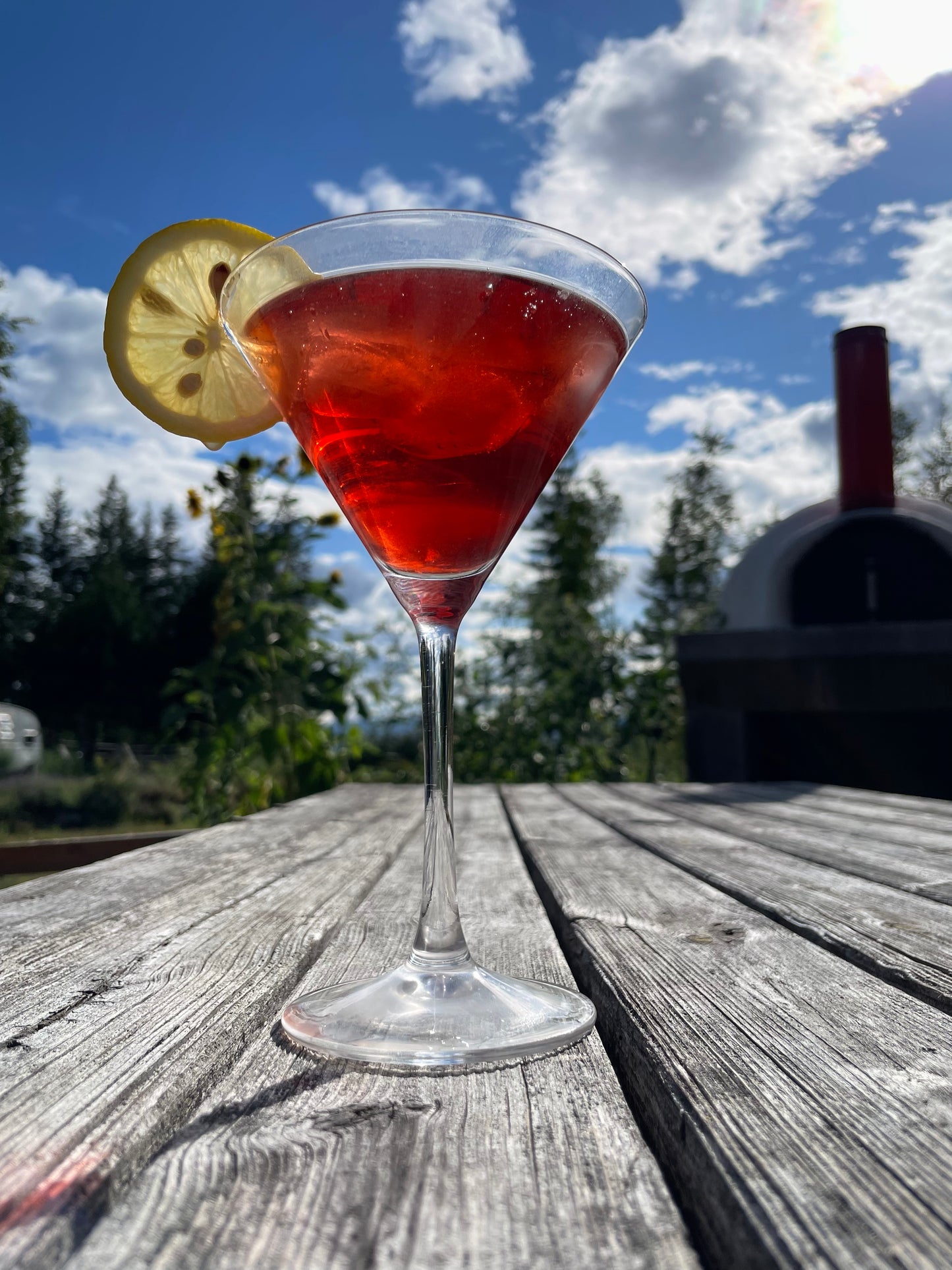 a martini glass with pink tea 